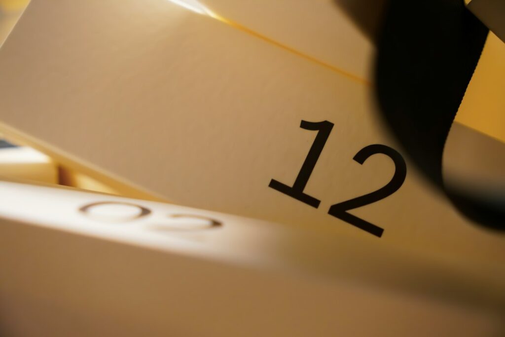 Close-up of the number 12 on a white surface