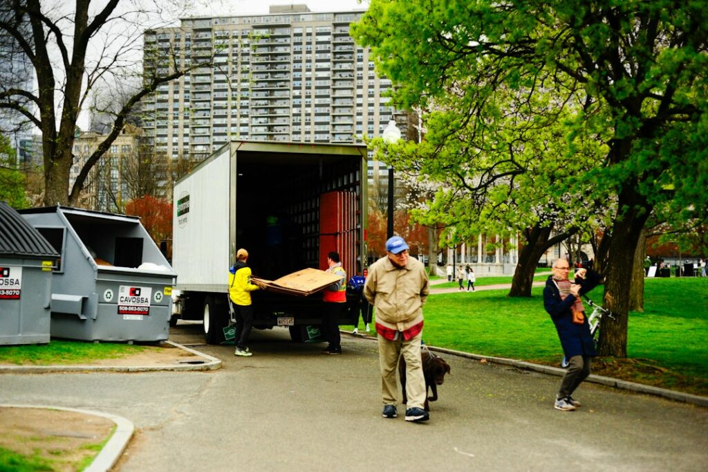 People unloading furniture from a moving truck outdoors