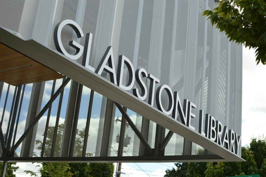 The Gladstone Library sign on a modern building with a perforated metal facade